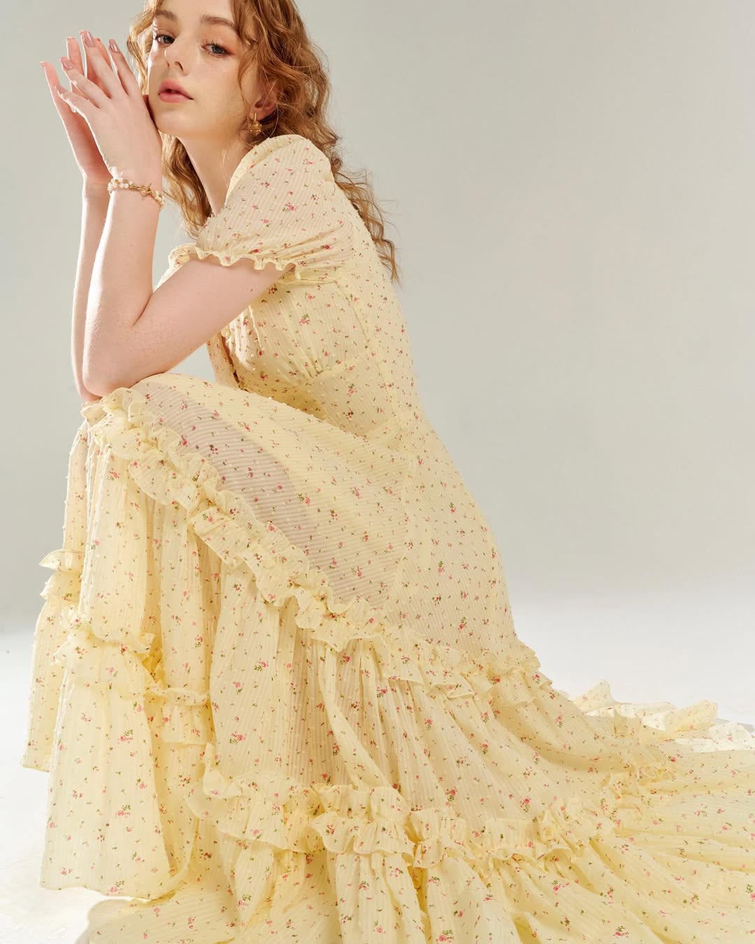 Juliet Dress by Tiffany Studio — yellow floral, seated with the skirt spread