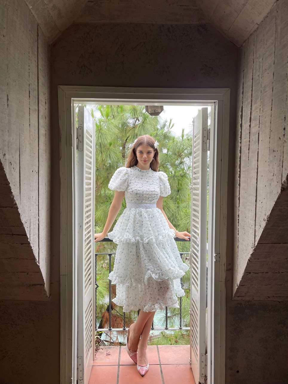 Charlise Dress Blue Edition by Tiffany Studio — white, leaning against a doorframe